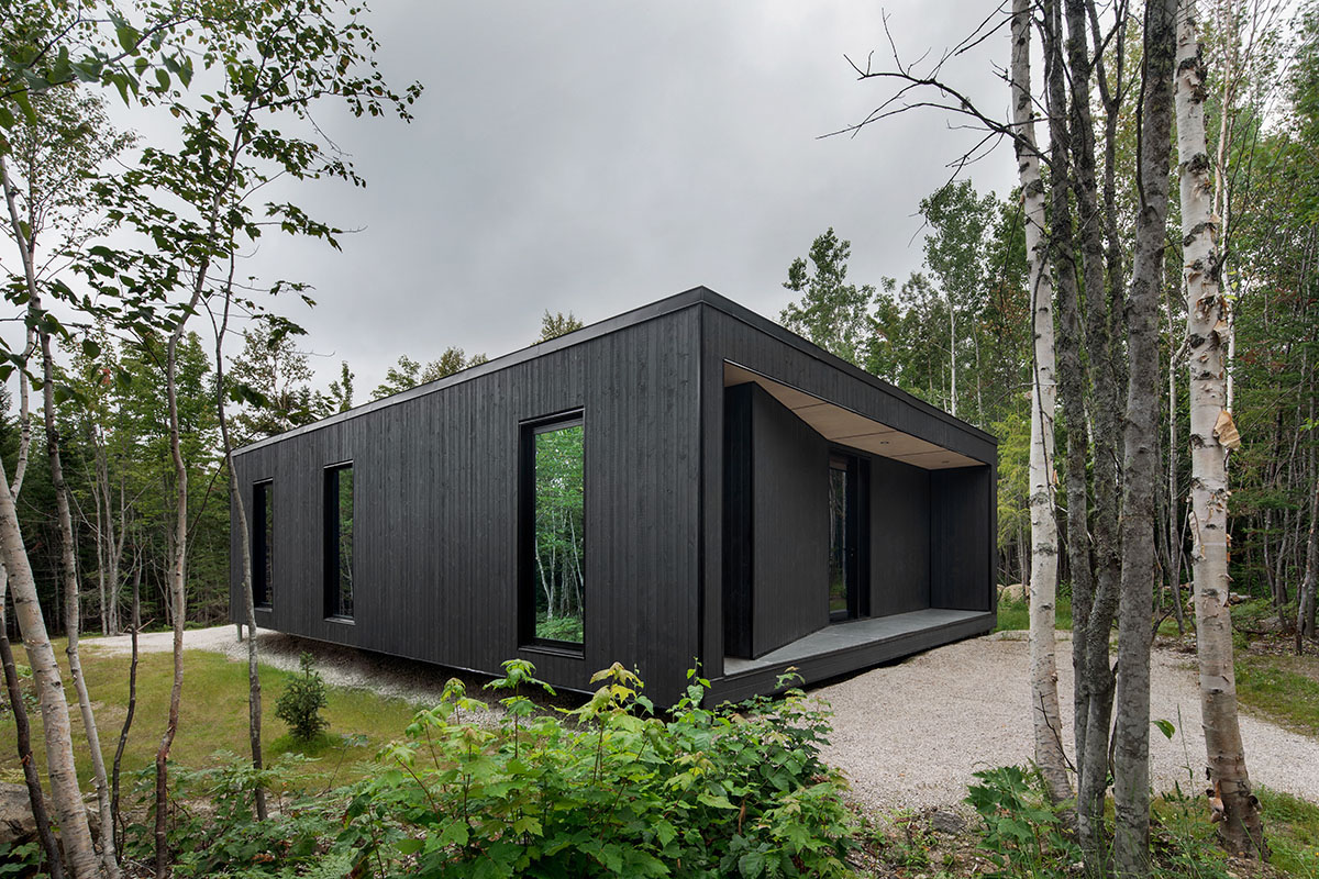 Bourgeois / Lechasseur architects built black wooden holiday cabin with mirrored façade in Québec