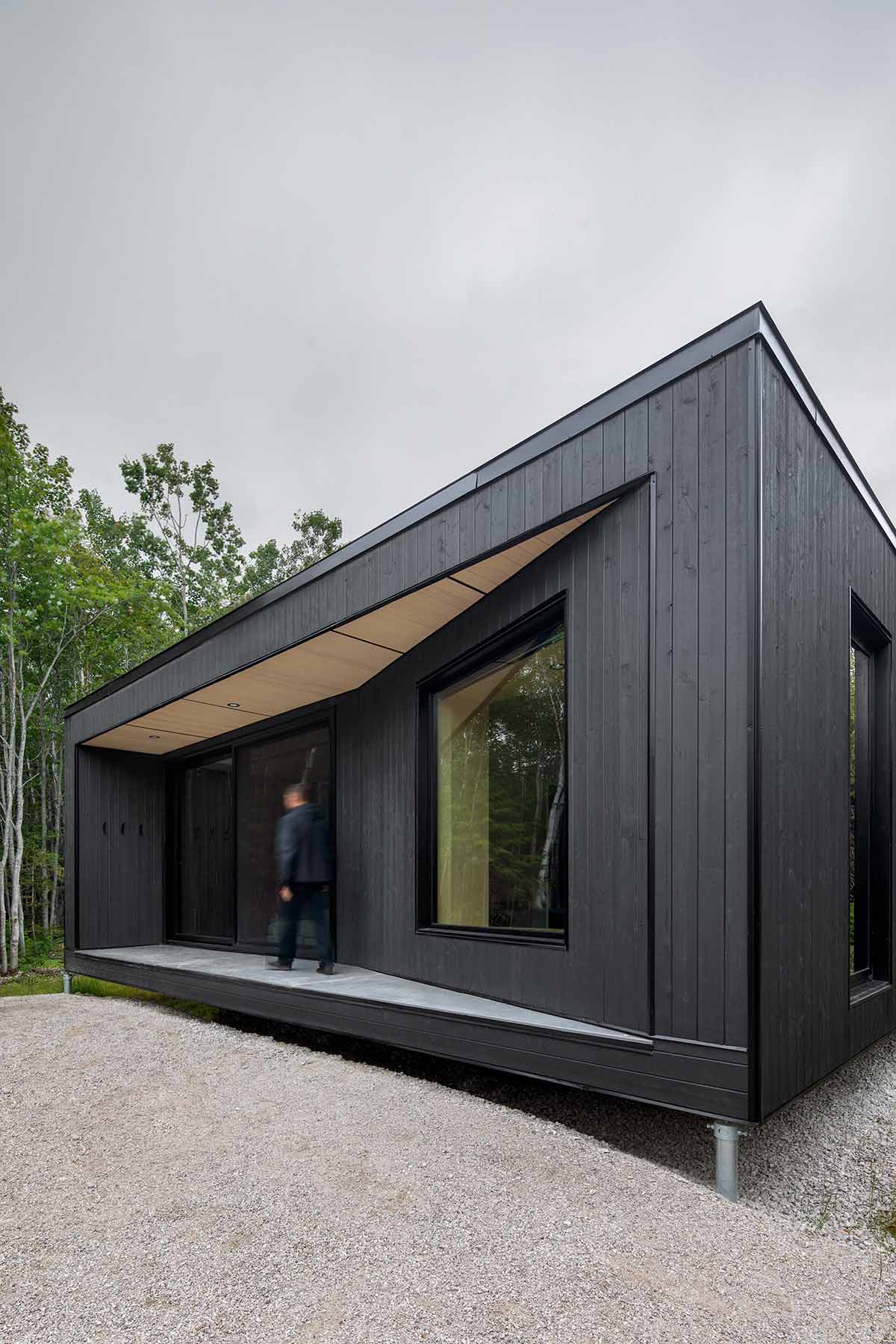 Bourgeois / Lechasseur architects built black wooden holiday cabin with mirrored façade in Québec