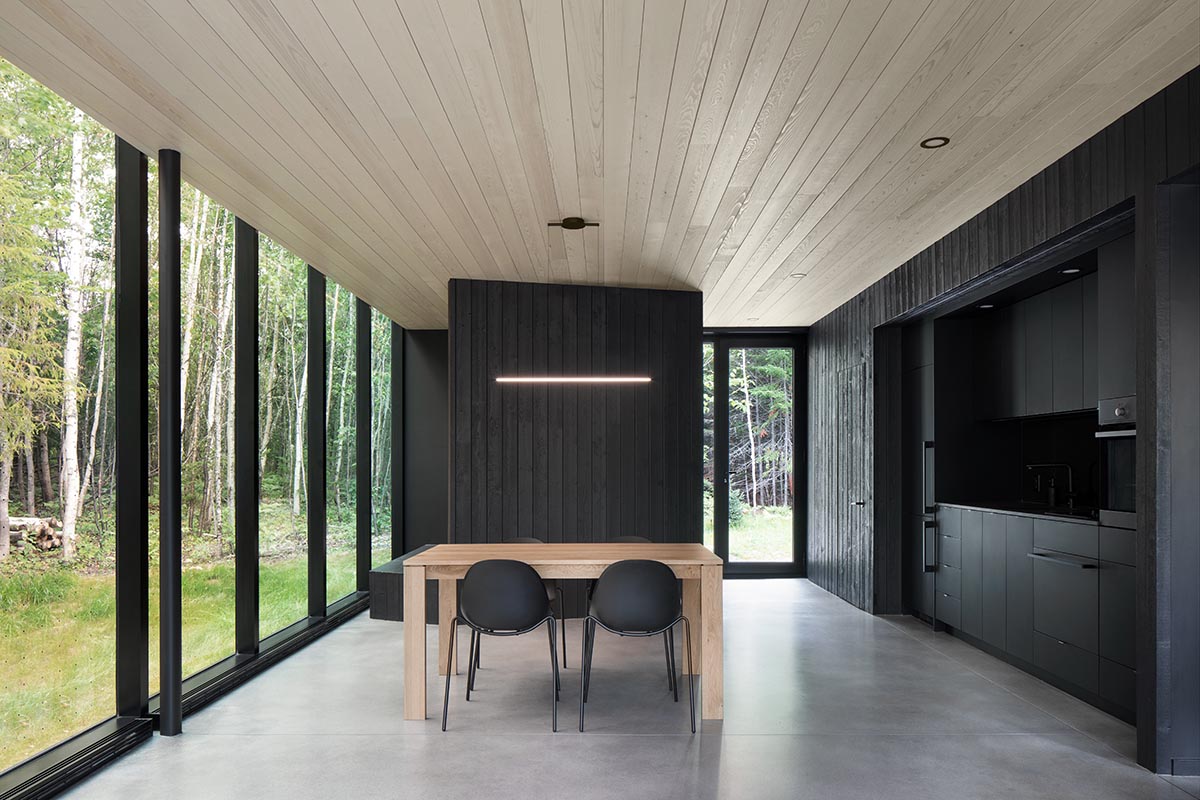 Bourgeois / Lechasseur architects built black wooden holiday cabin with mirrored façade in Québec