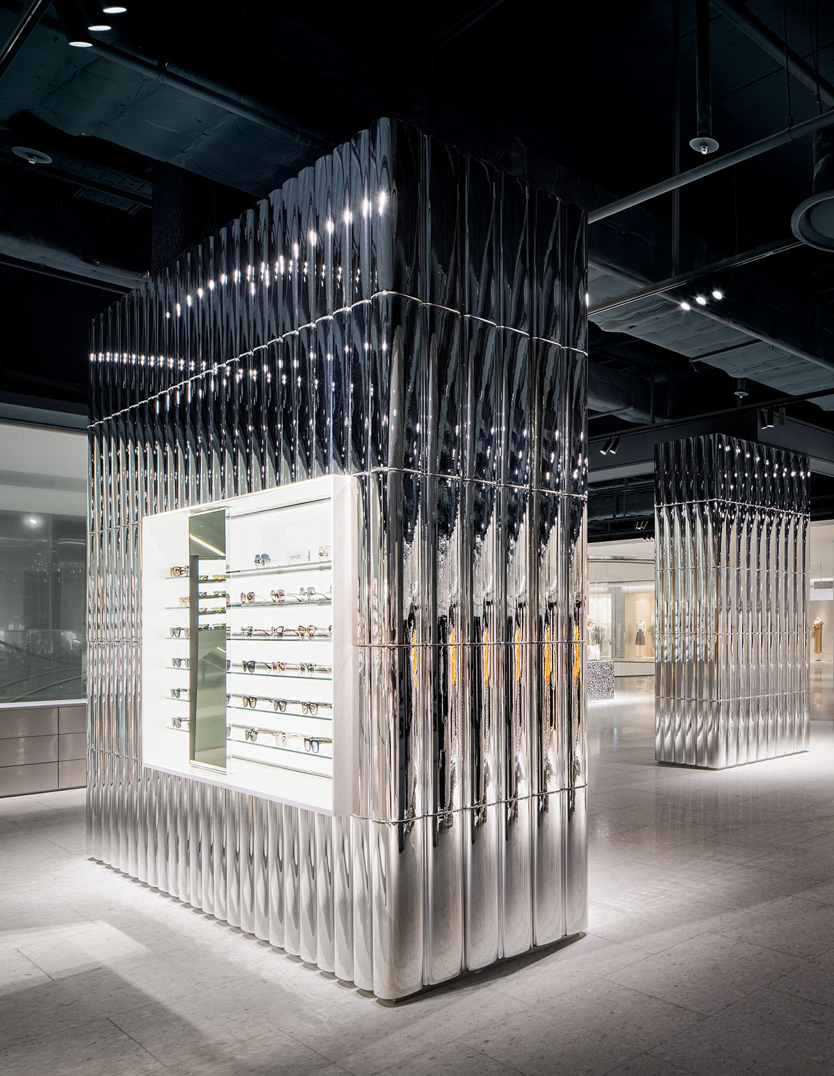 Burdifilek designs gallery-like interiors spaces featuring metallic surfaces and fluid forms