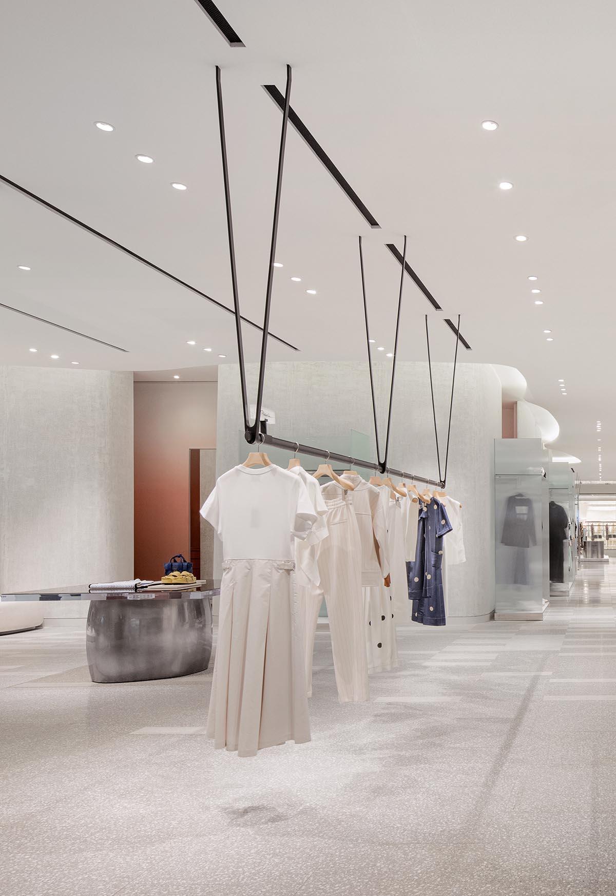 Burdifilek designs gallery-like interiors spaces featuring metallic surfaces and fluid forms