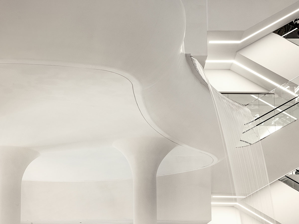 Burdifilek designs gallery-like interiors spaces featuring metallic surfaces and fluid forms