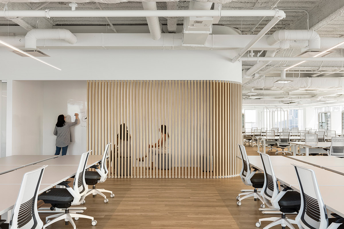 ISSADESIGN merges linear elements and curved working pods for interiors of Behavox in Montreal