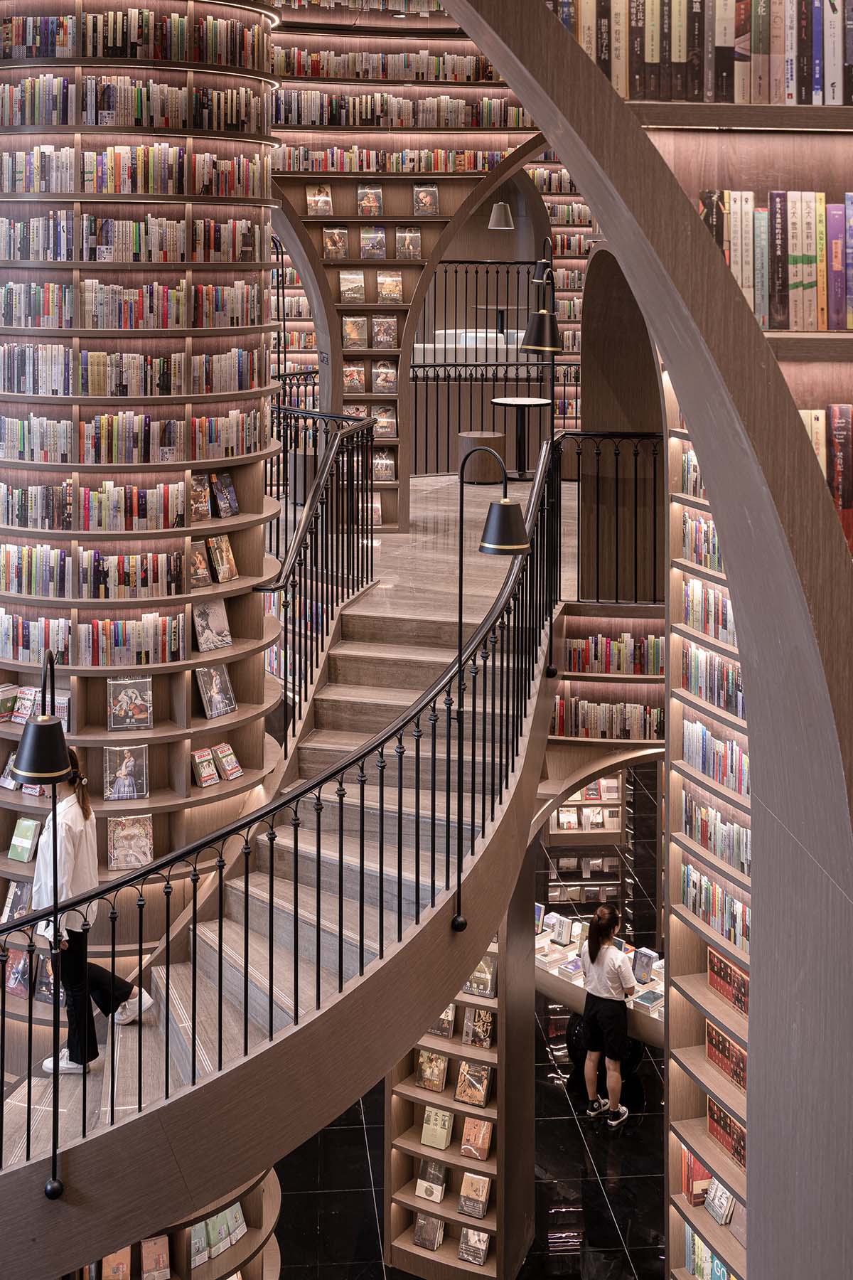 Reading a book is like stepping into a bamboo forest made of endless bookshelves designed by X+Living