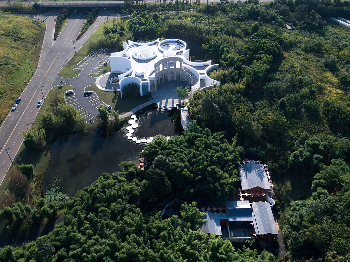 aoe designs Chinese Cultural Hall with cross-shaped arch columns nestled in a bamboo forest