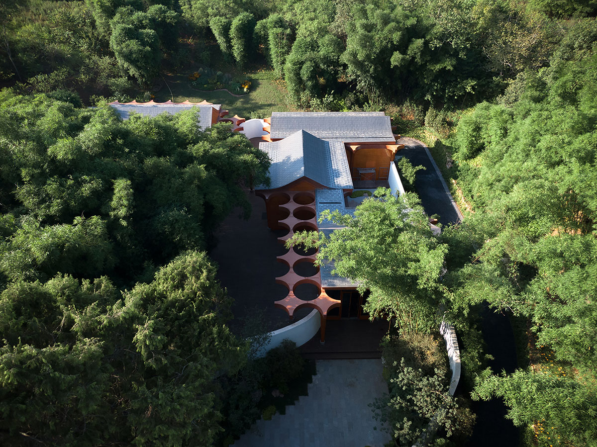 aoe designs Chinese Cultural Hall with cross-shaped arch columns nestled in a bamboo forest