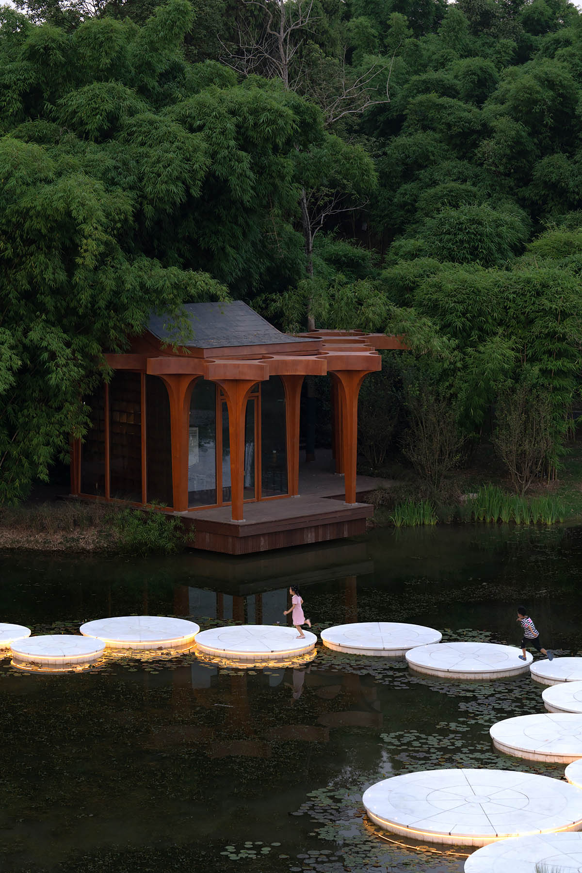 aoe designs Chinese Cultural Hall with cross-shaped arch columns nestled in a bamboo forest