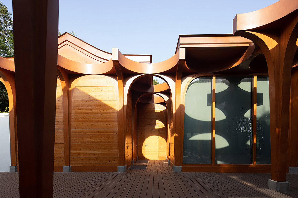 aoe designs Chinese Cultural Hall with cross-shaped arch columns nestled in a bamboo forest