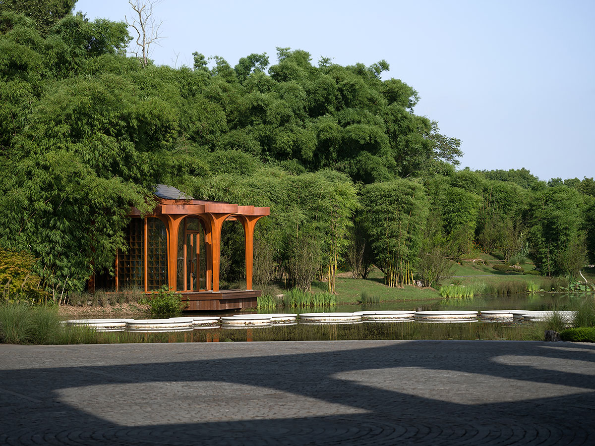 aoe designs Chinese Cultural Hall with cross-shaped arch columns nestled in a bamboo forest