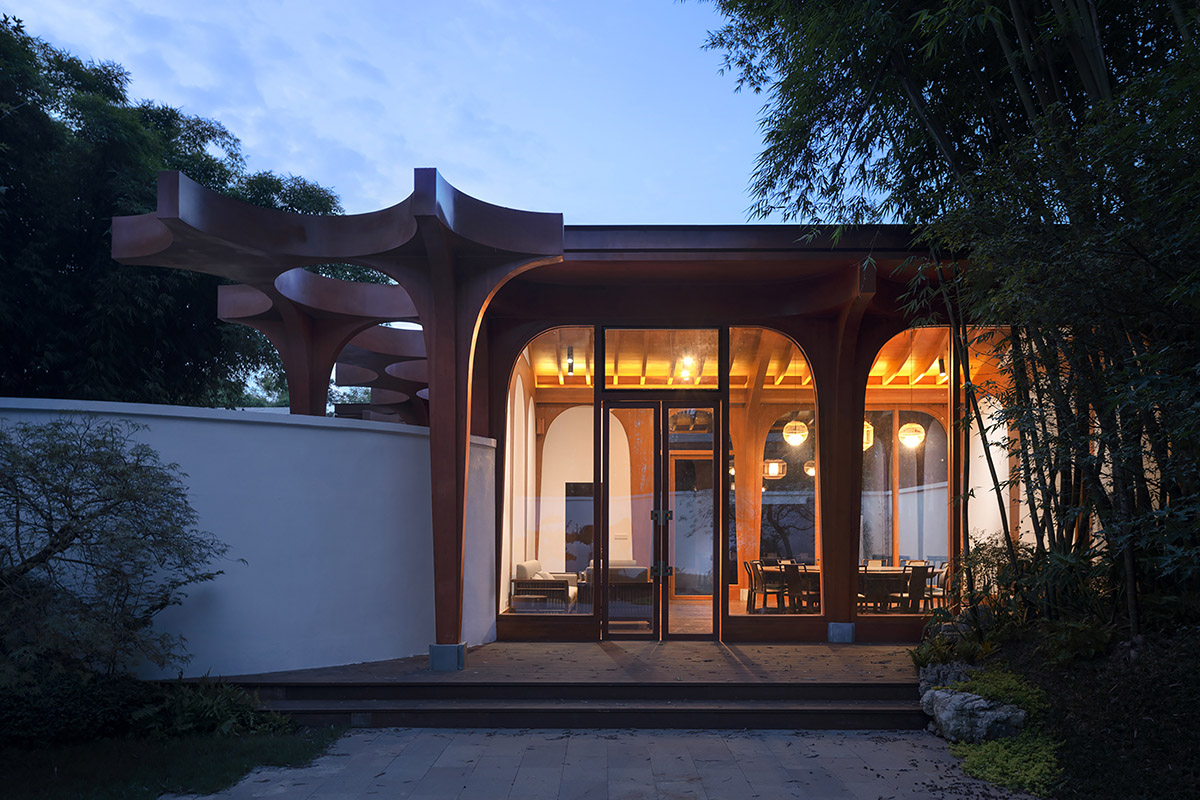 aoe designs Chinese Cultural Hall with cross-shaped arch columns nestled in a bamboo forest