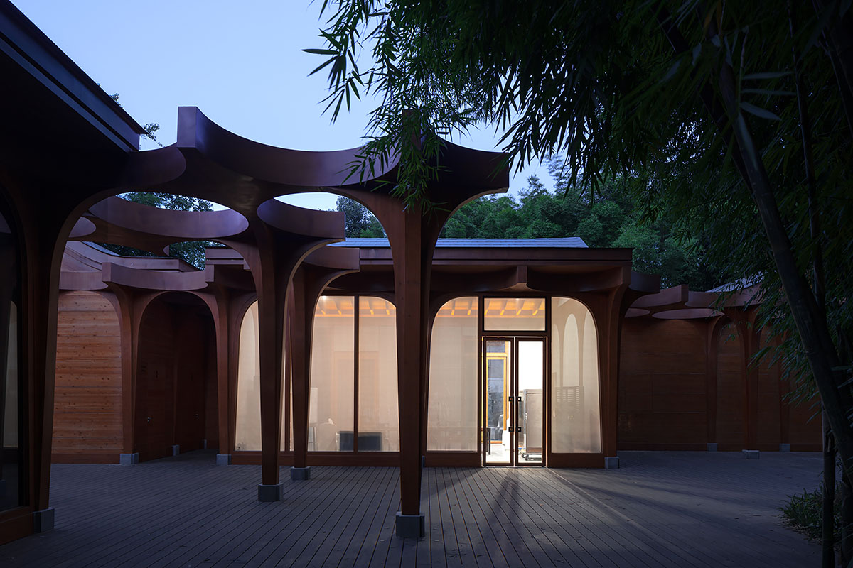 aoe designs Chinese Cultural Hall with cross-shaped arch columns nestled in a bamboo forest