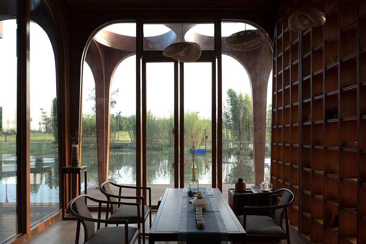 aoe designs Chinese Cultural Hall with cross-shaped arch columns nestled in a bamboo forest