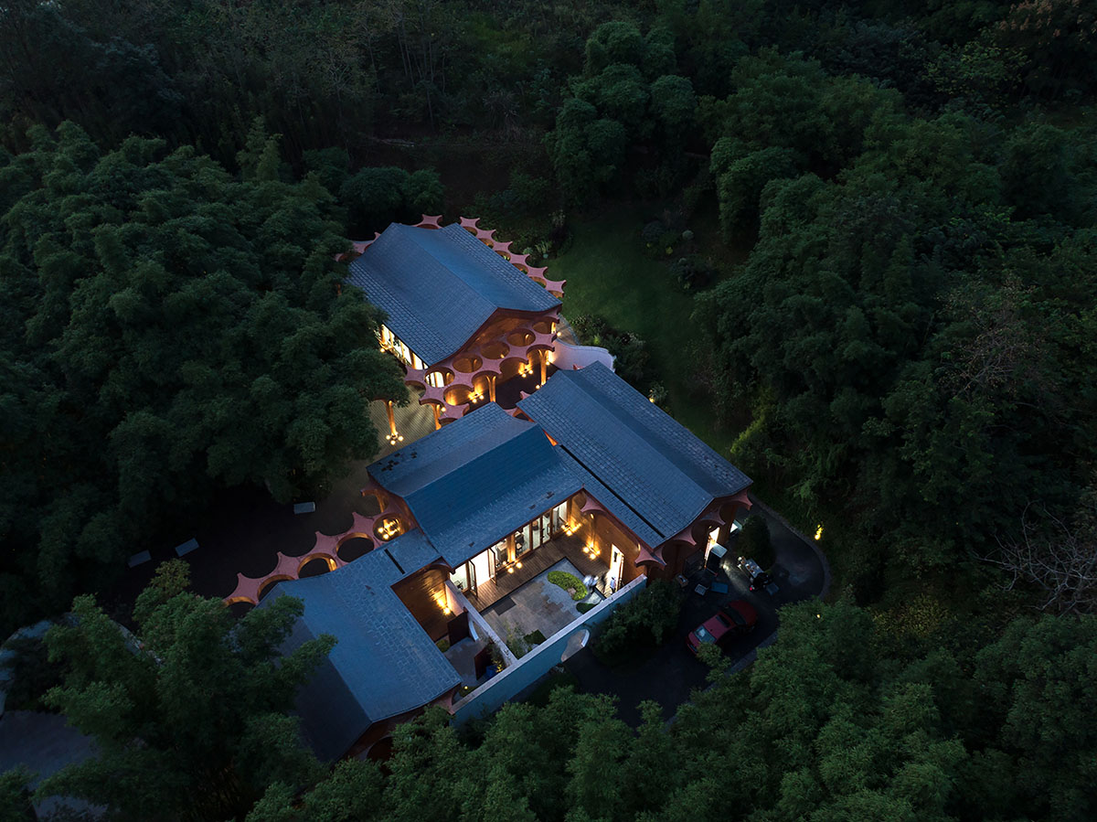 aoe designs Chinese Cultural Hall with cross-shaped arch columns nestled in a bamboo forest