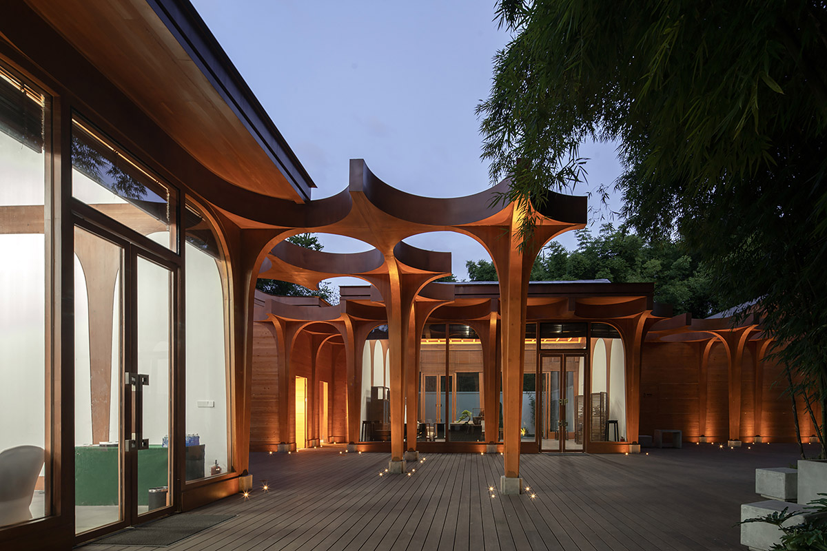 aoe designs Chinese Cultural Hall with cross-shaped arch columns nestled in a bamboo forest