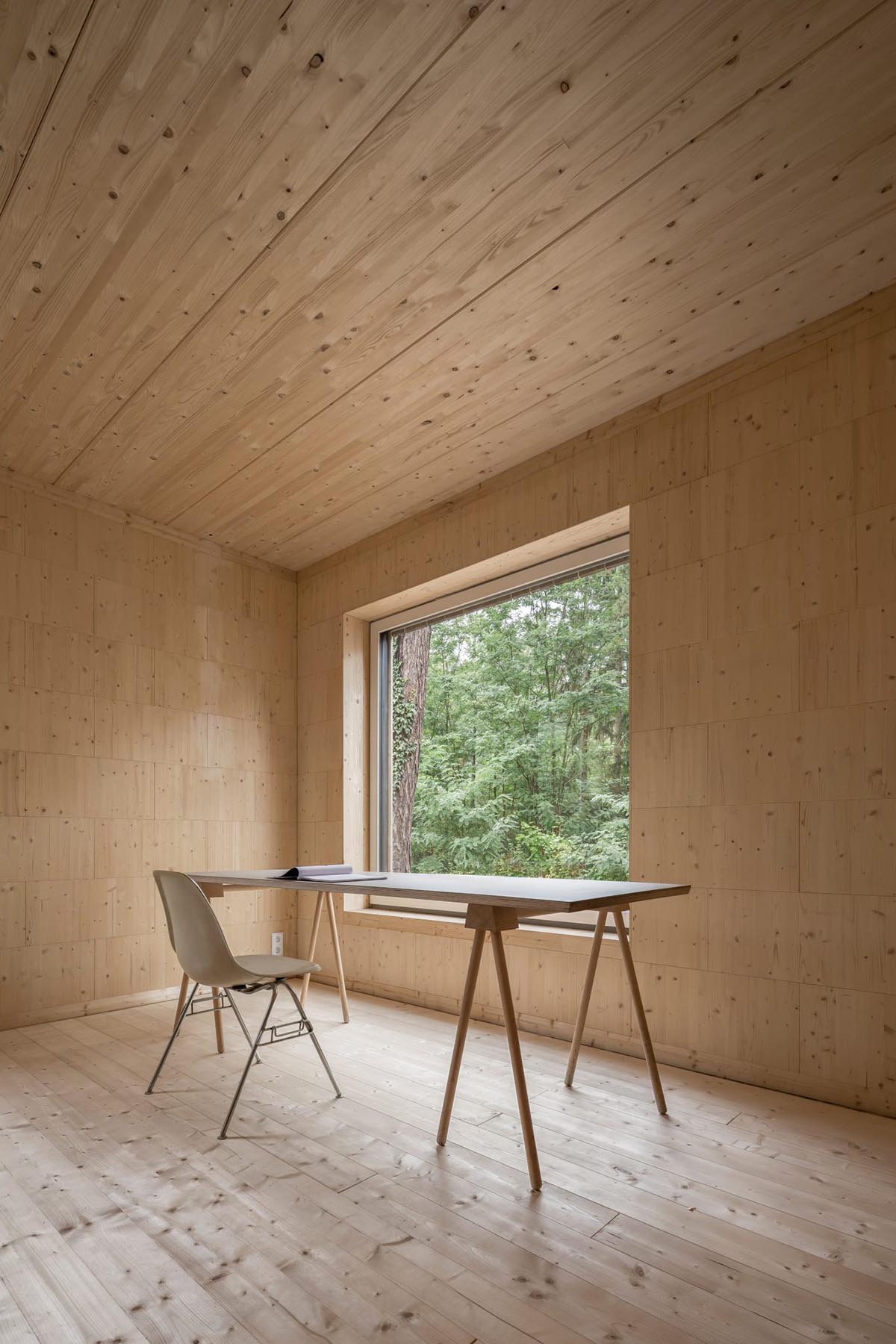 Zeller & Moye built private residence composed of interlocked timber cabins among pine trees
