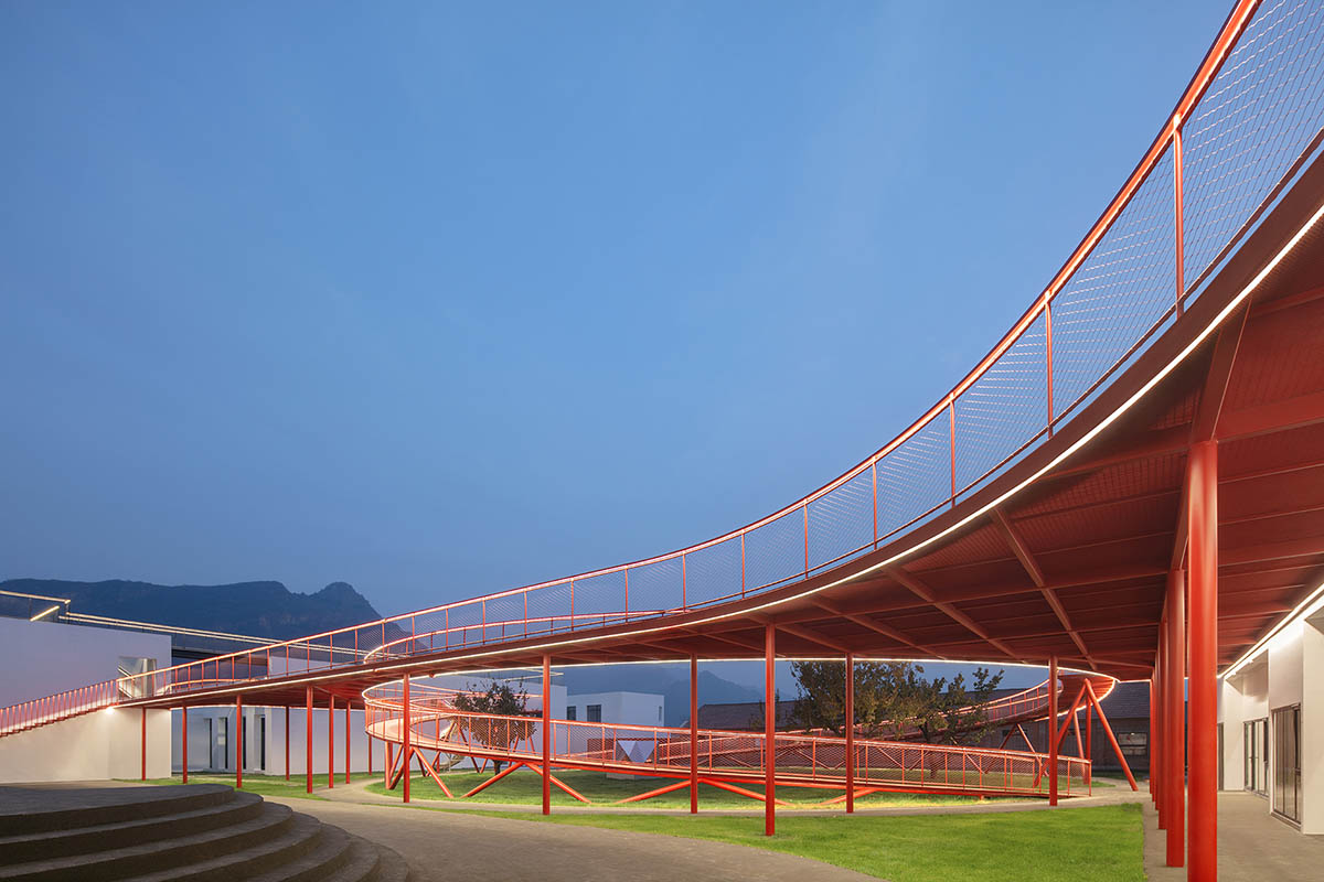 REDe Architects and Moguang Studio add red circular platform to renovated youth activity center