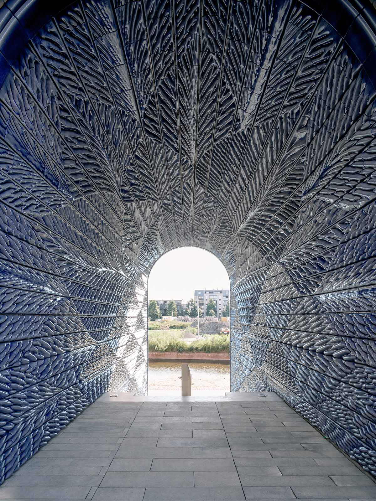 Studio RAP clads two gates of PoortMeesters residential building block in 3D blue porcelain
