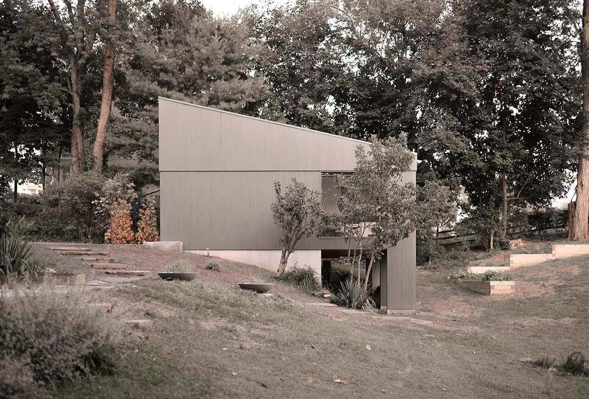 An artist's studio floats and illuminates in the landscape in Germantown