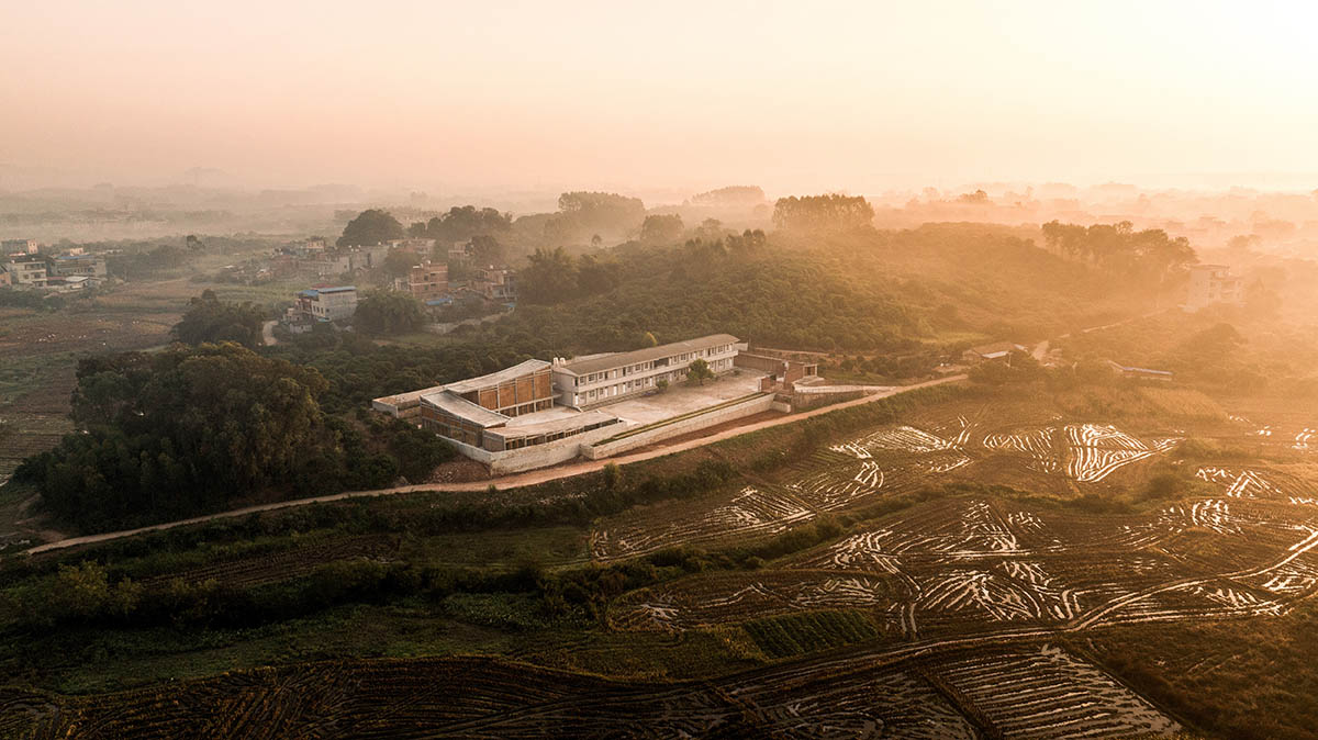 Staggered volumes define educational and cultural centre shaped around the pond in China