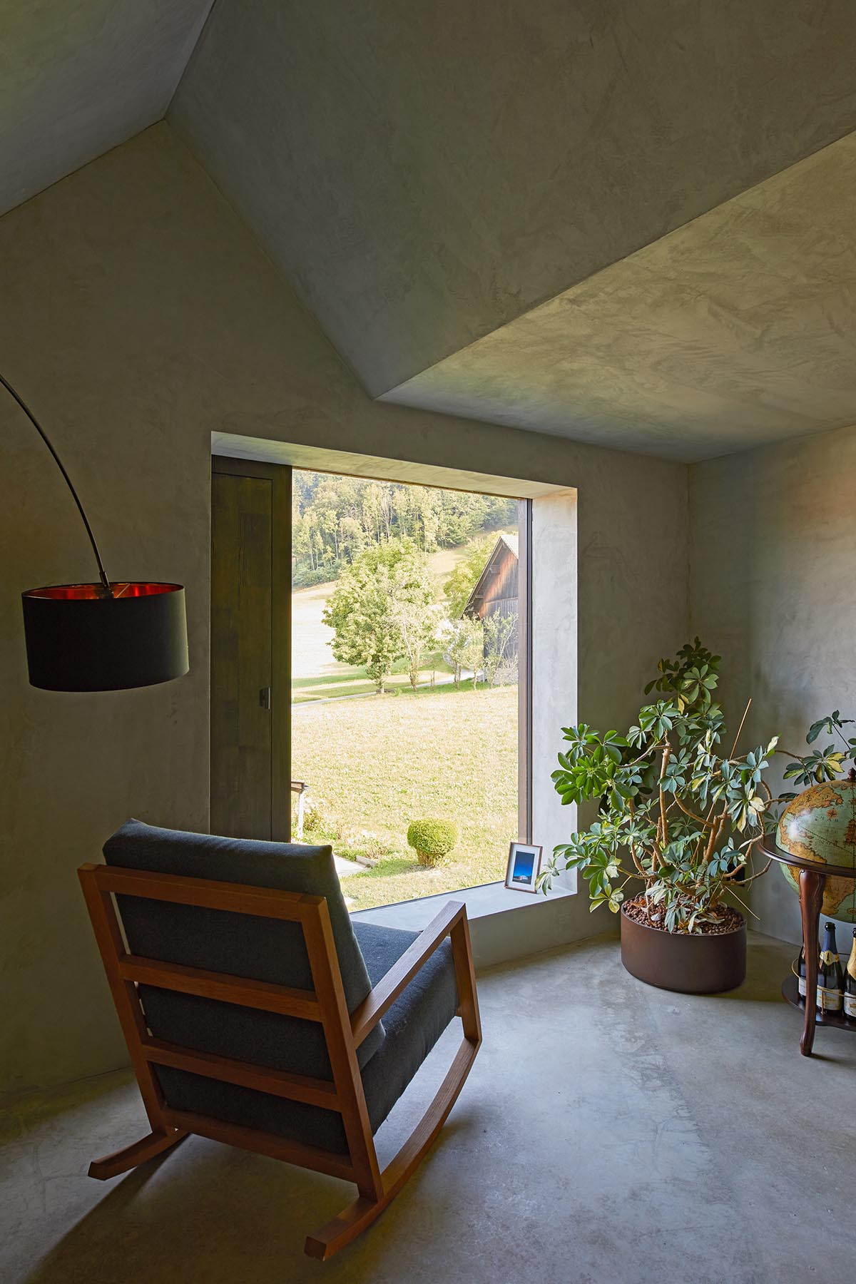 Residential barn features an unfinished, raw interior in Swiss rural landscape