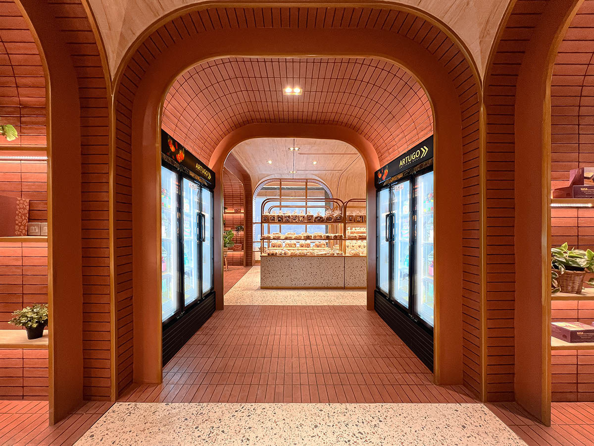 Bakery interior mimics arches and portals with bright red bricks in Papua, Indonesia 