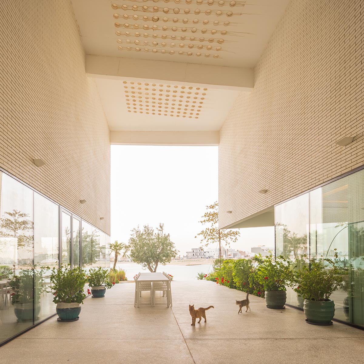 Family house is covered by folded roof to create a tent-like structure on Kuwait's seaside 