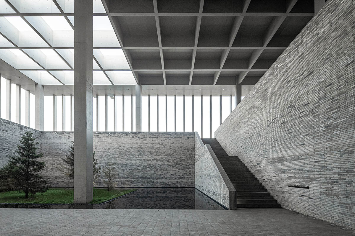 Grey brick walls wrap a factory building referencing to local construction methods in China 
