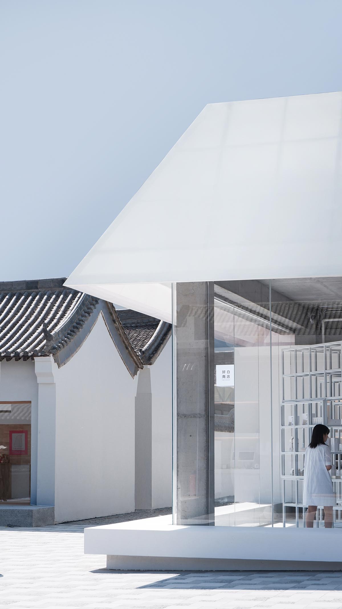 A shop is attached to Beijing historic Hutong houses with white-colored skin