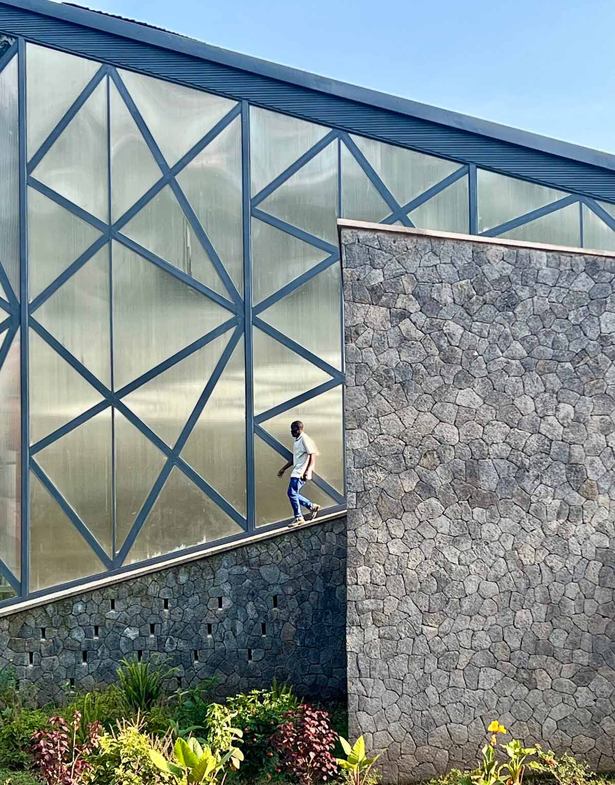 Striking geometric glass geometry resembles an open eye at a distillery in Rwanda