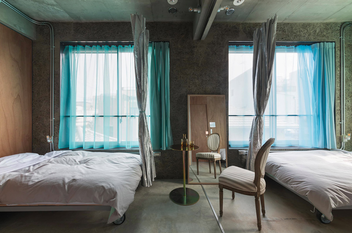 Tato Architects creates painted effect to this concrete hotel by using colourful curtains in Osaka