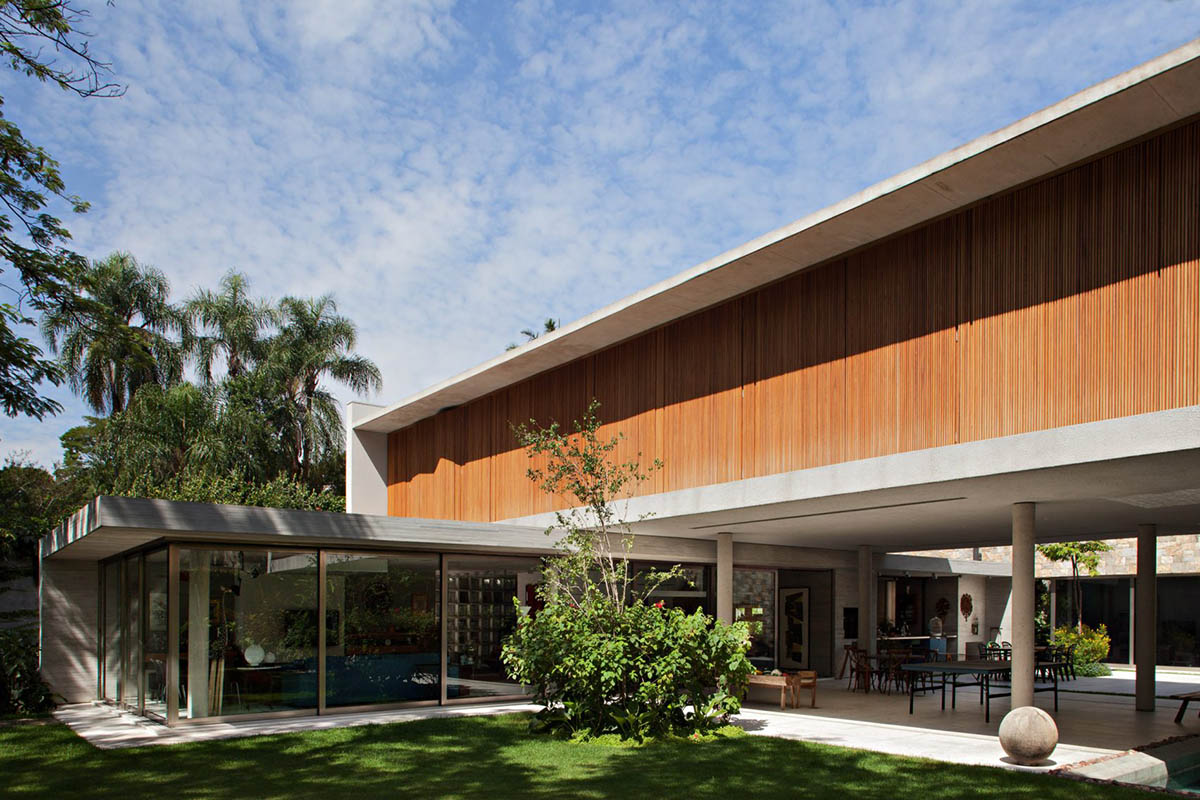 Perkins+Will's Cidade Jardim House features a large garden space under thin columns