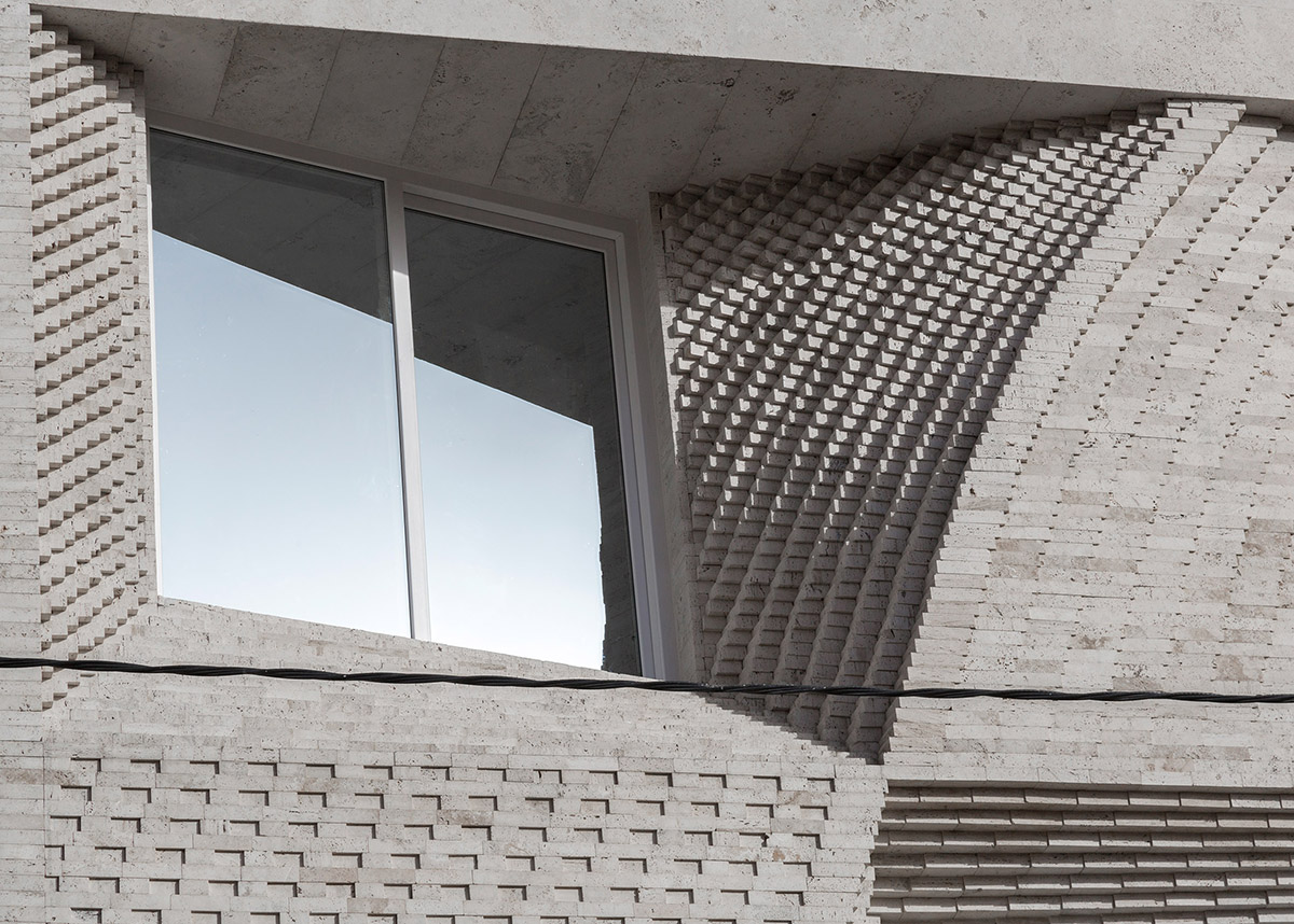 CAAT Studio creates spatial variations of stone on the facade of this Iranian residential building