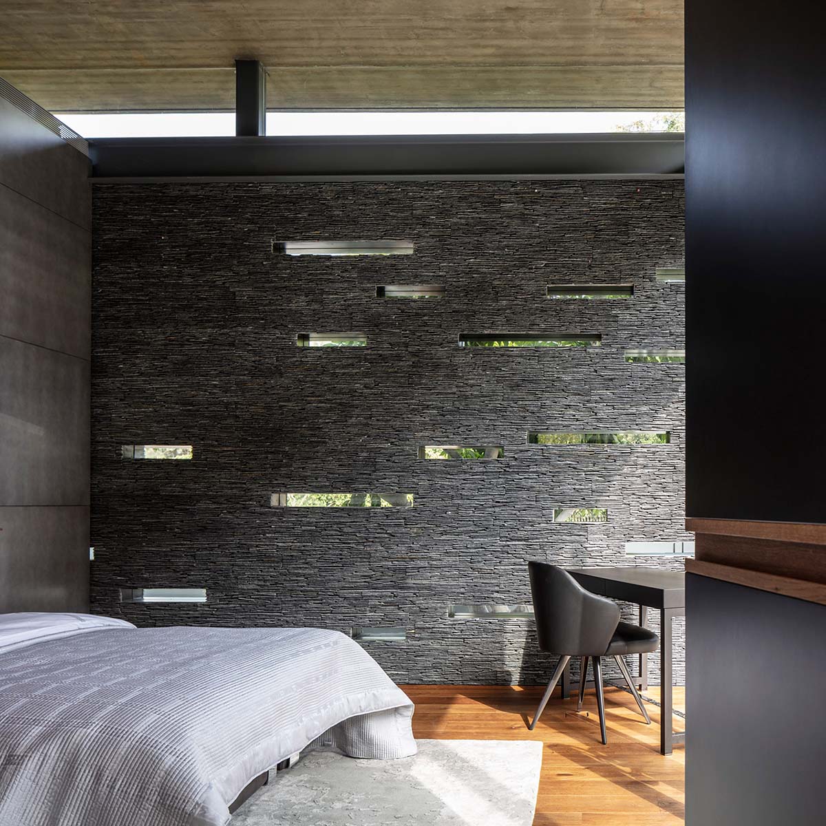 Pitsou Kedem Architects' black Pavilion House is reflected onto a linear swimming pool in Israel
