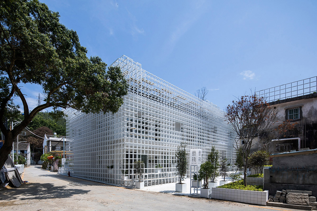 Aether Architects converted old village house into a local hostel by wrapping with structural lattice