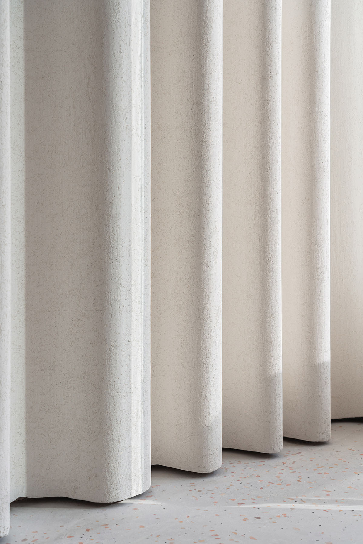 say architects uses curved tiled walls to merge exterior and interior for a patisserie in Hangzhou