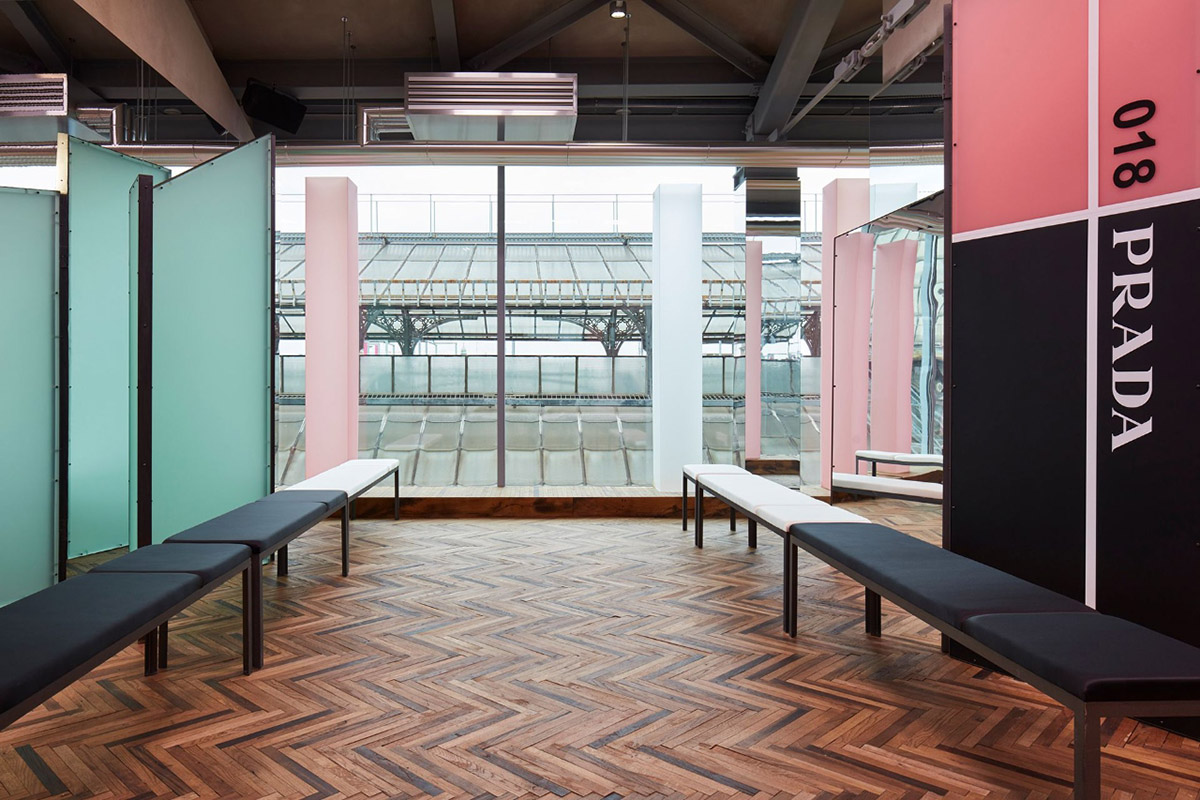 AMO filled Prada 2018 Resort stage with pink columns, continuous mirrors and disoriented seatings
