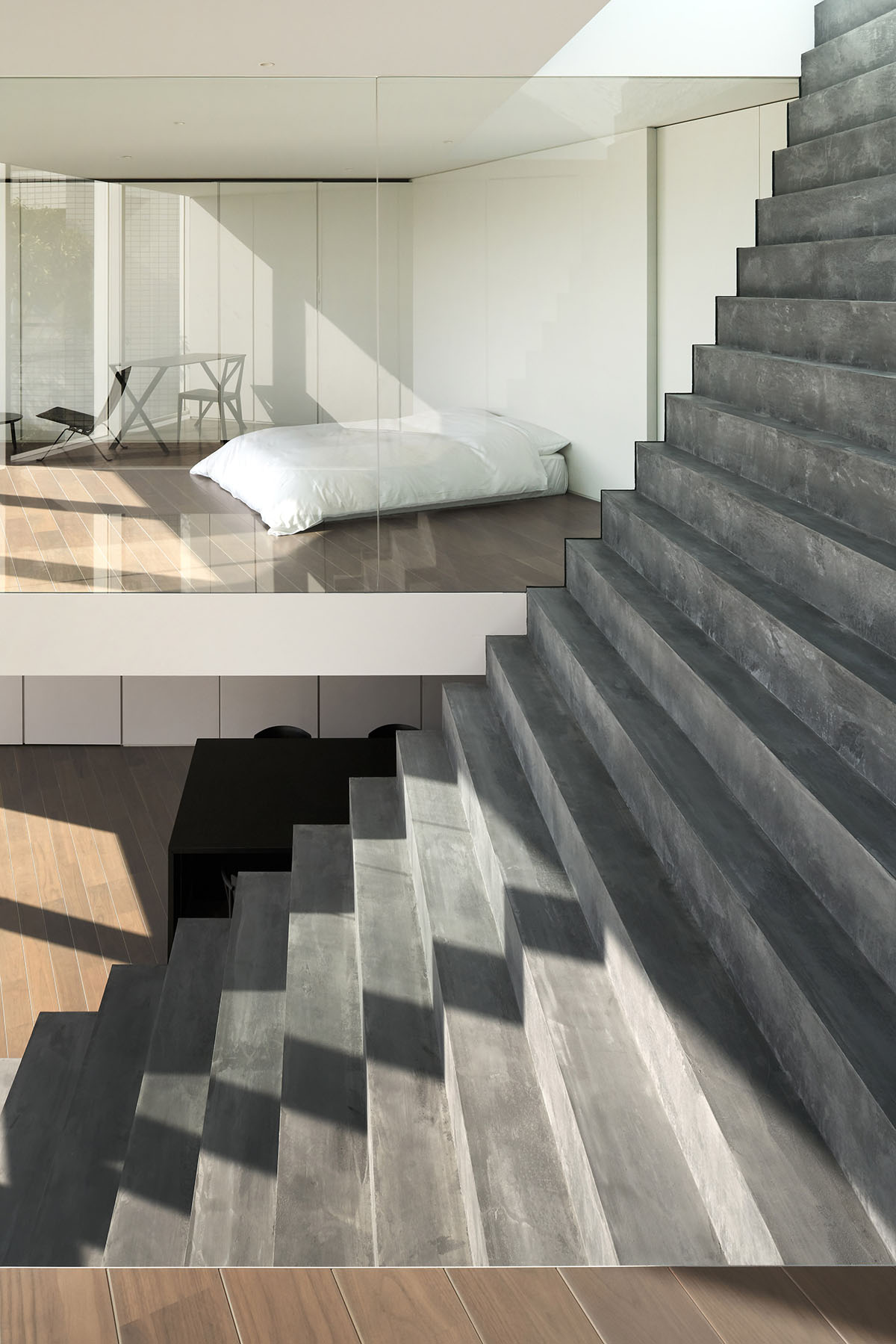 Nendo's two-family house in Tokyo features giant functional stairway passing through the facade