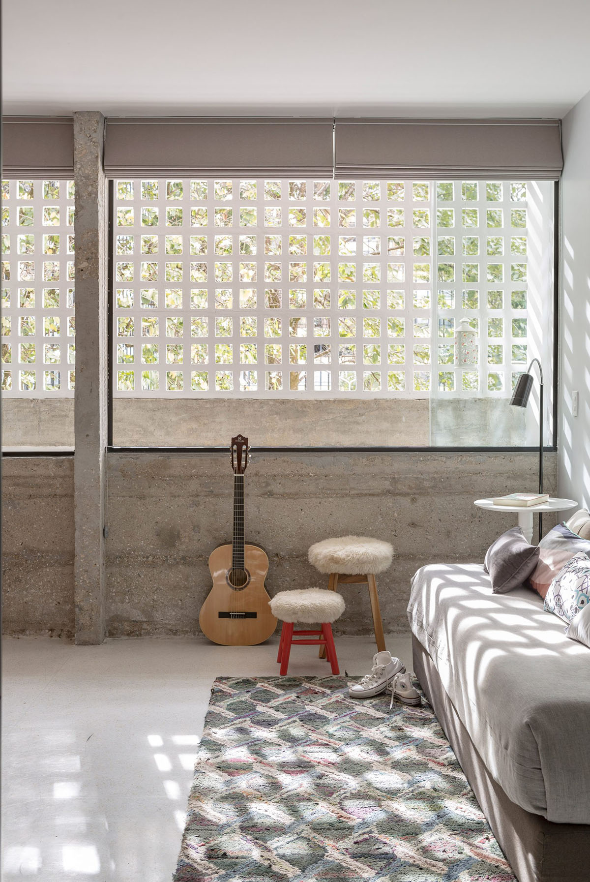 A historic Brazilian apartment has been redesigned with wooden bookcase as main divider