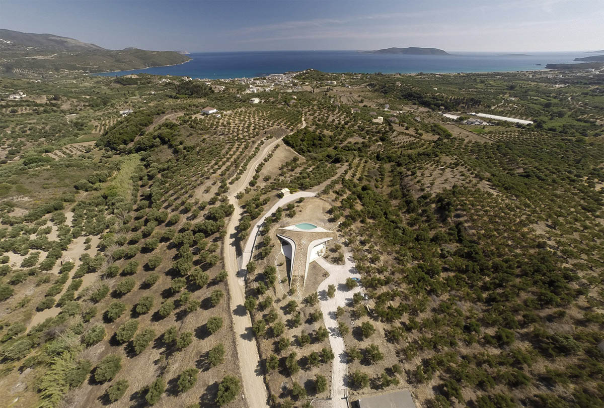 Ypsilon summer house embedded in landscape overlooking Peloponnese’s olive grove