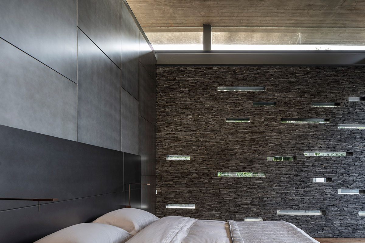 Pitsou Kedem Architects' black Pavilion House is reflected onto a linear swimming pool in Israel