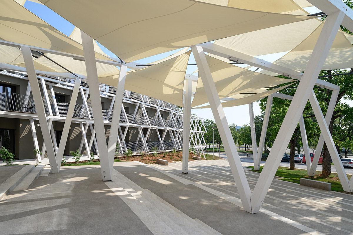 Enota designs hotel with aggressive façade made of white fences in Slovenia