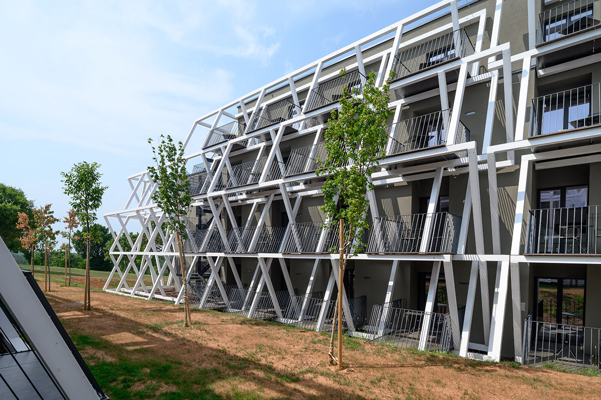 Enota designs hotel with aggressive façade made of white fences in Slovenia