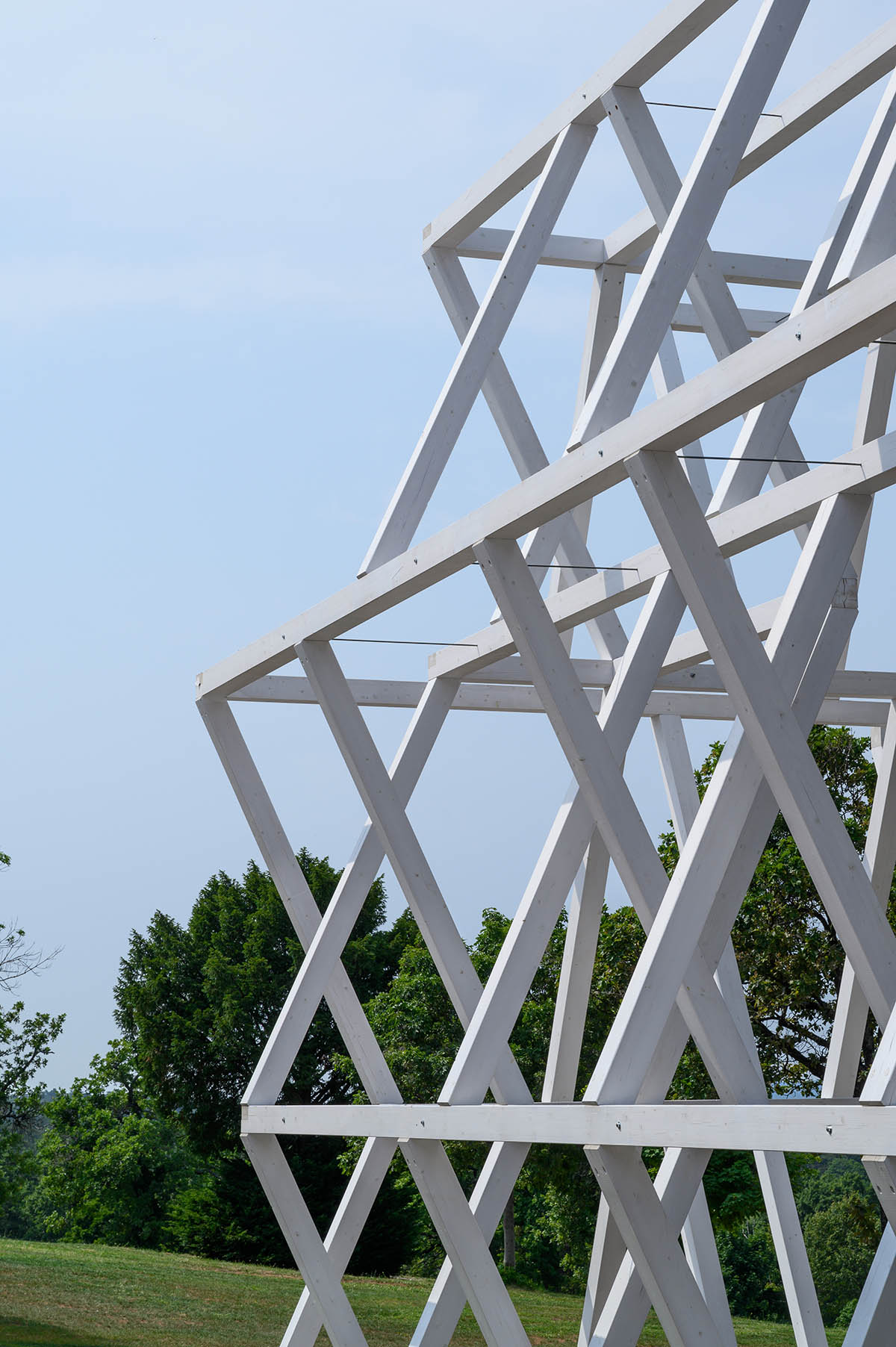 Enota designs hotel with aggressive façade made of white fences in Slovenia