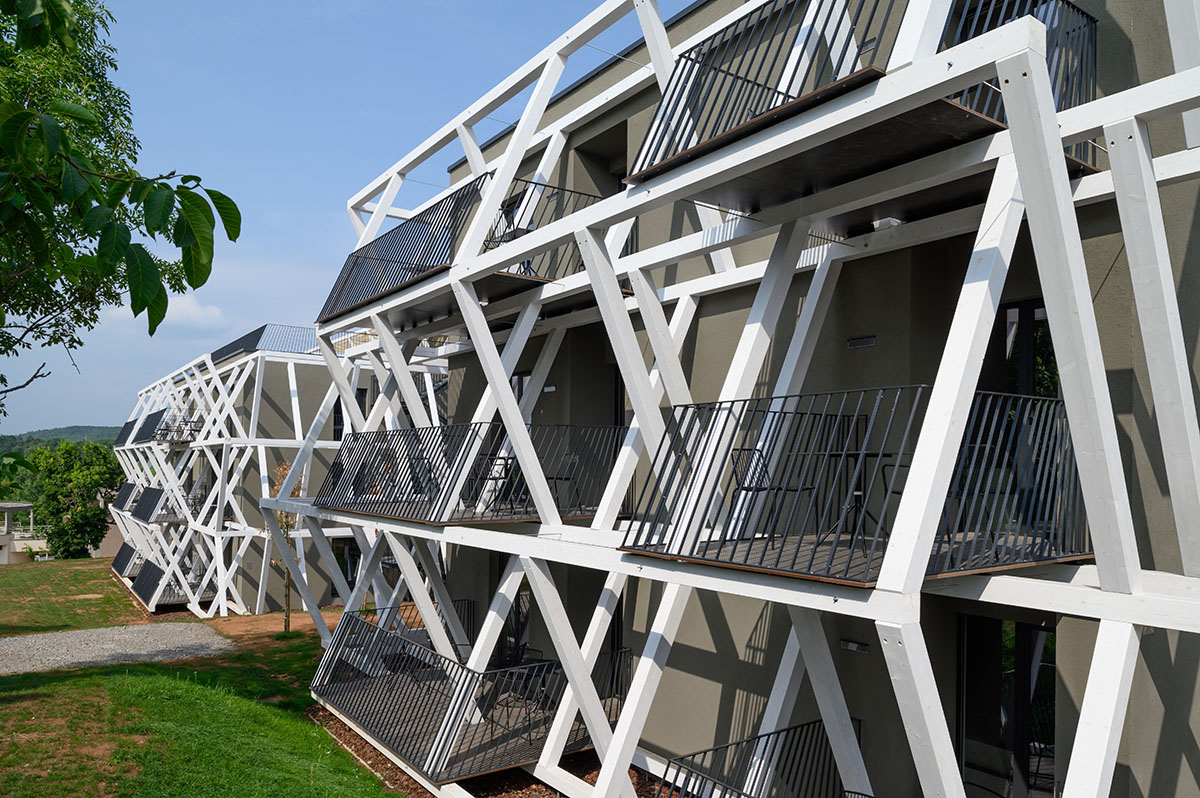 Enota designs hotel with aggressive façade made of white fences in Slovenia