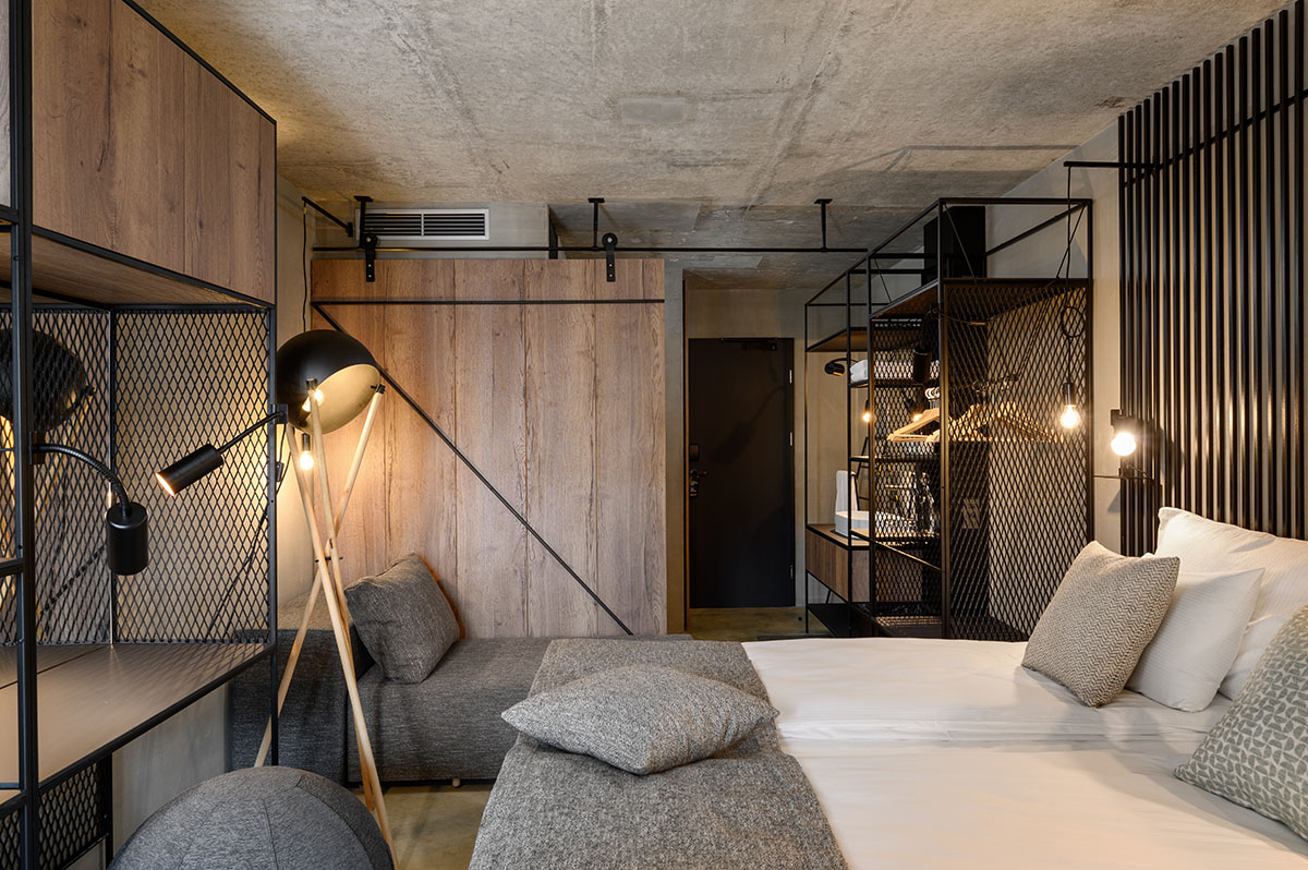 Enota designs hotel with aggressive façade made of white fences in Slovenia