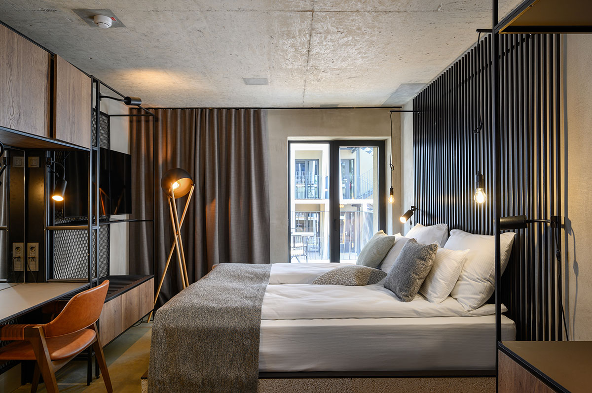 Enota designs hotel with aggressive façade made of white fences in Slovenia