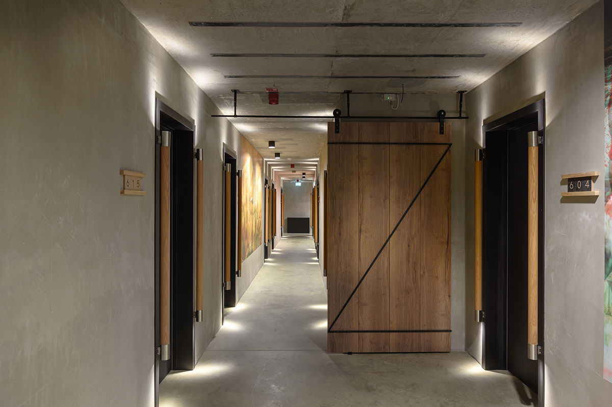 Enota designs hotel with aggressive façade made of white fences in Slovenia