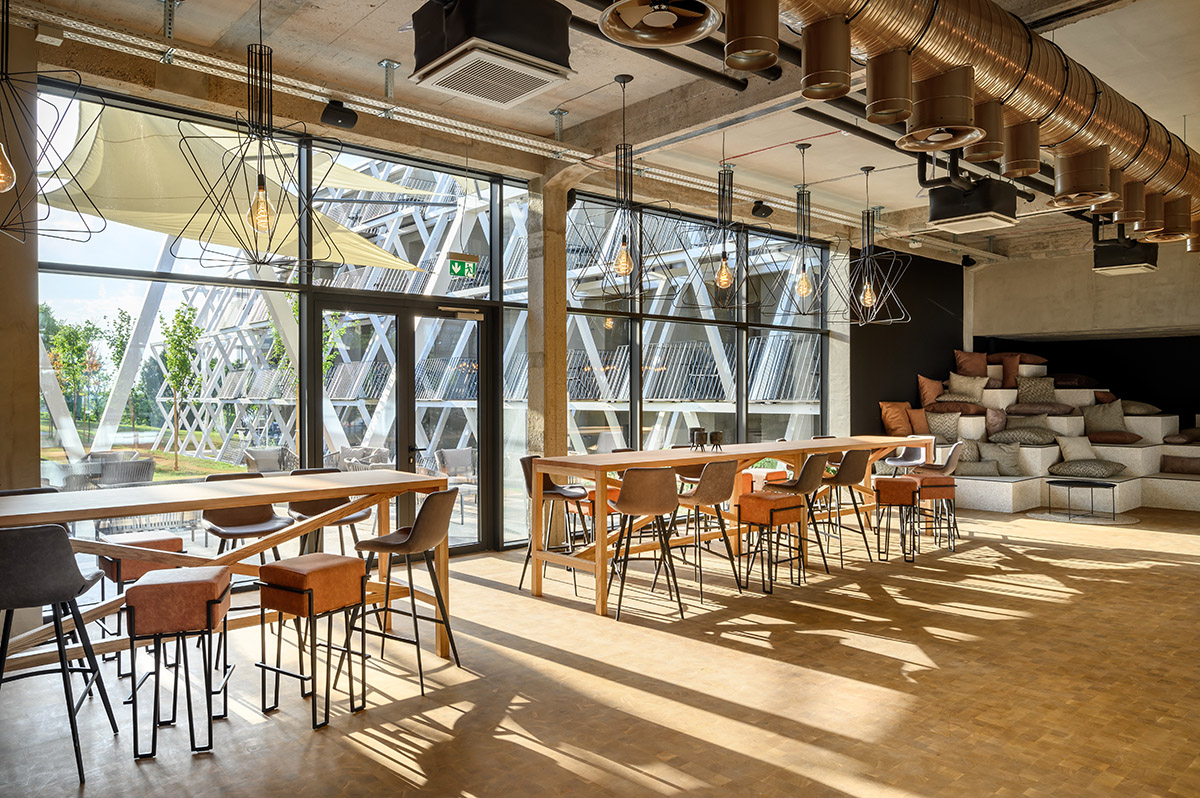 Enota designs hotel with aggressive façade made of white fences in Slovenia