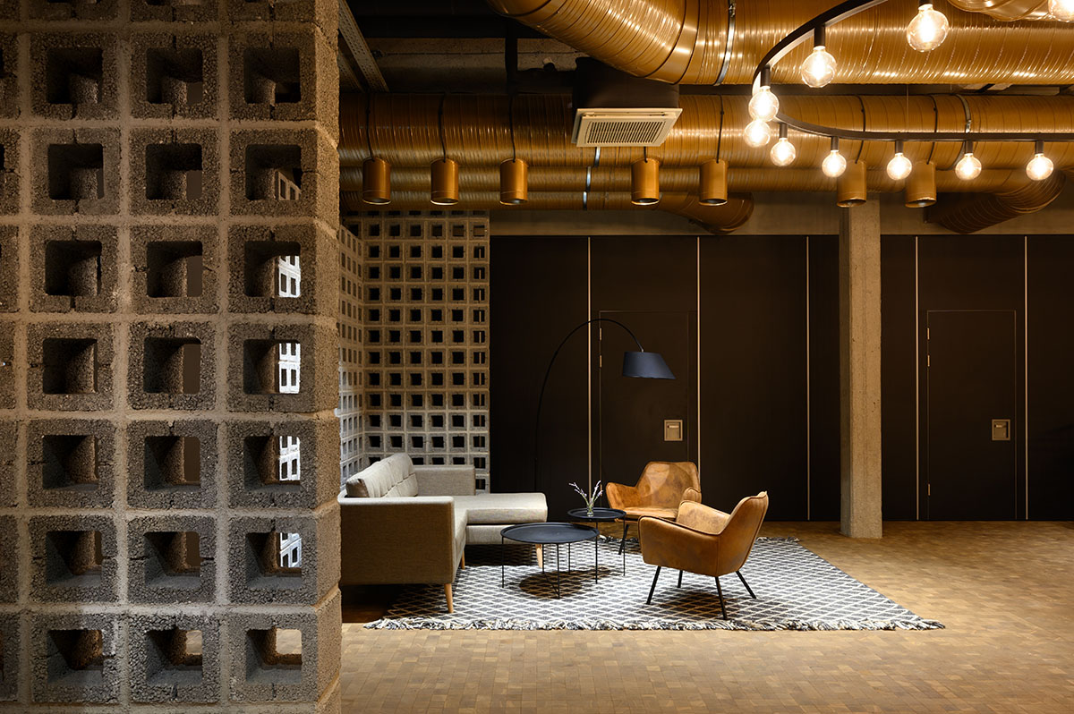 Enota designs hotel with aggressive façade made of white fences in Slovenia