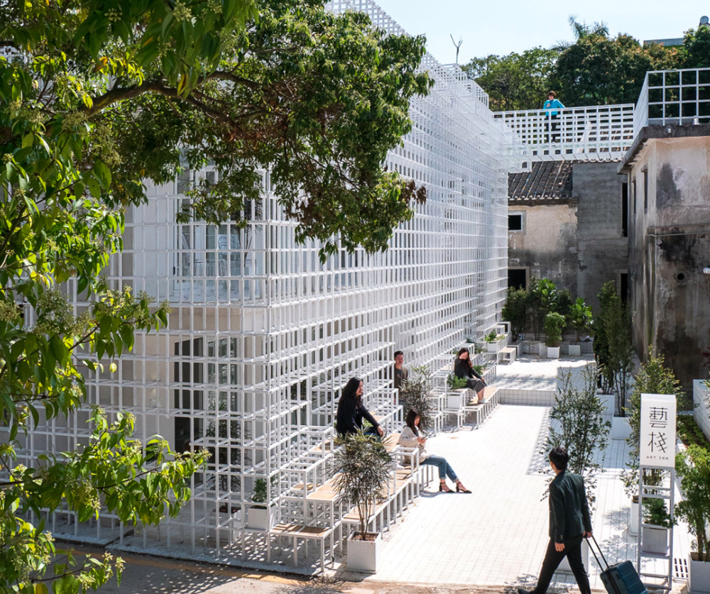 Aether Architects converted old village house into a local hostel by wrapping with structural lattice
